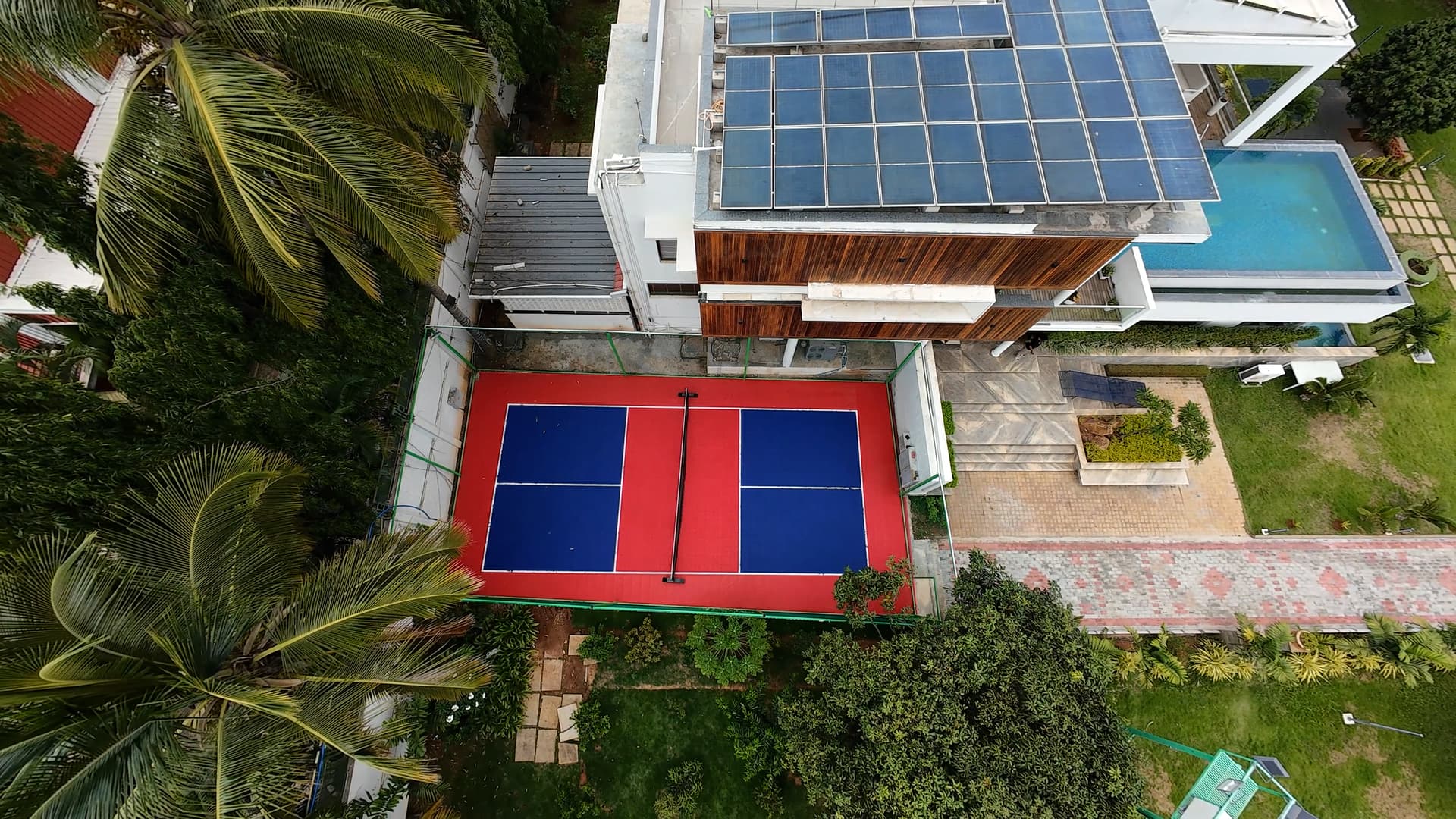 Aerial view of the villa with pickleball court and swimming pool.